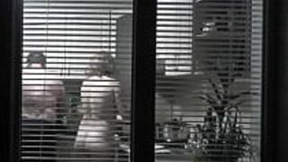 Peeping. Voyeur. Neighbor pervert voyeur in evening on street looks out window as naked sexy neighbor in kitchen prepares dinner for her husband. Naked in public. Naked at home. Family. Outdoor porn video